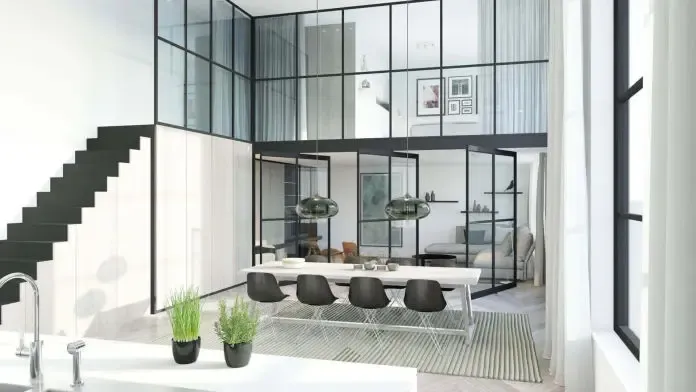 Divisiones de vidrio de estilo crittall con retícula negra en un interior diáfano de doble altura en Girona