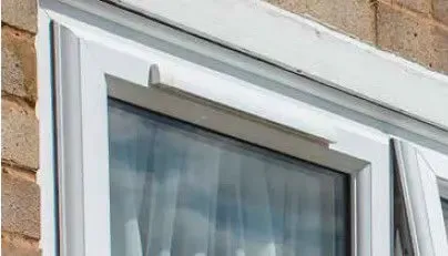 Ventana de PVC blanca con sistema de ventilación instalada en una vivienda de Girona