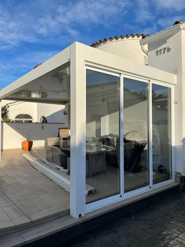 Galería con techo de panel autoportante y cortinas de cristal perimetrales