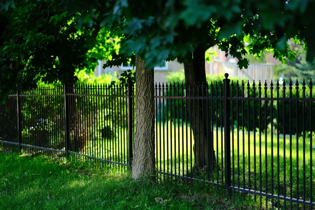 Tancament de parcel·la d'alumini en un jardí amb arbrat